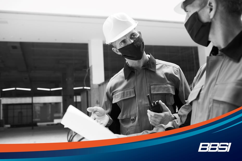2 men wearing personal protective equipment