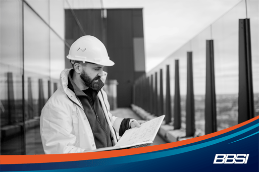 Engineer standing on construction site looking over business initiatives