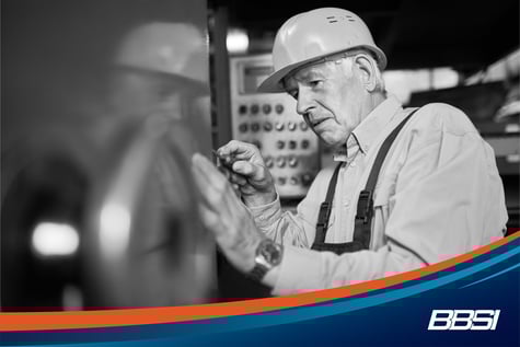 Senior electrician fixing machine and working towards his retirement plan