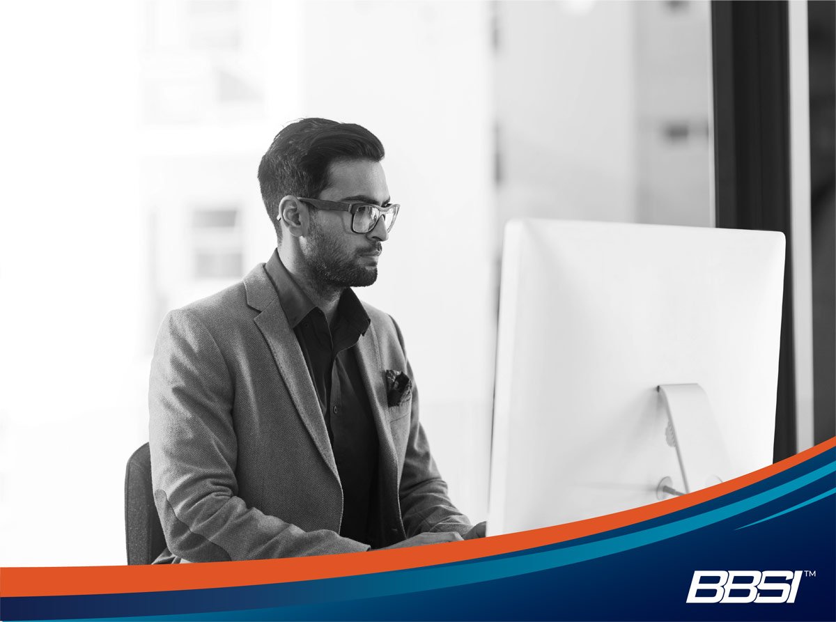 Business professional researching the difference between PEO vs payroll services