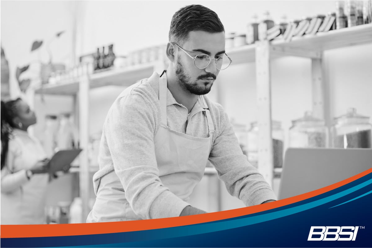 Small business owner reviewing health insurance options on a laptop before the enrollment deadline