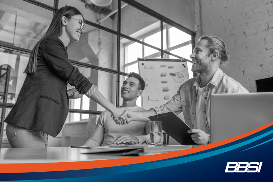 Businesswoman shaking hands with a businessman in a conference room