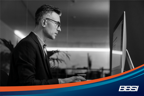 A businessman sitting at a computer reading about the Corporate Transparency Act