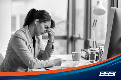 Woman sitting at her desk worrying about how to terminate an employee