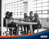 Group of people sitting at a table, shaking hands