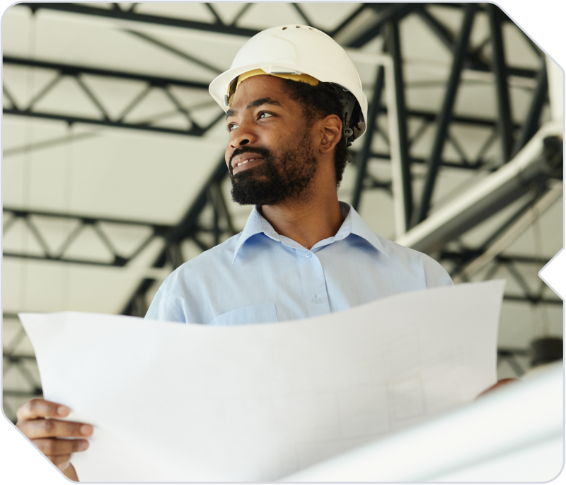 A project engineer holding floorplans on a jobsite.