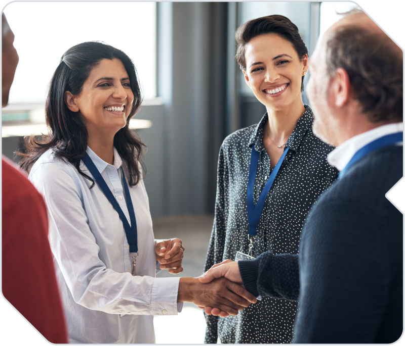 Business owners shaking hands at a networking event.