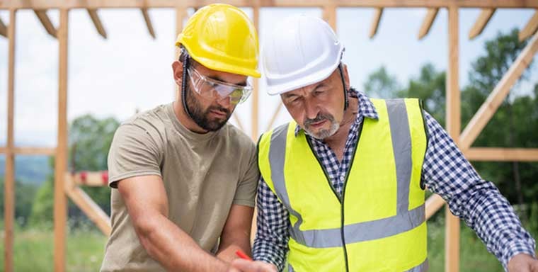Construction workers building a property with safety gear
