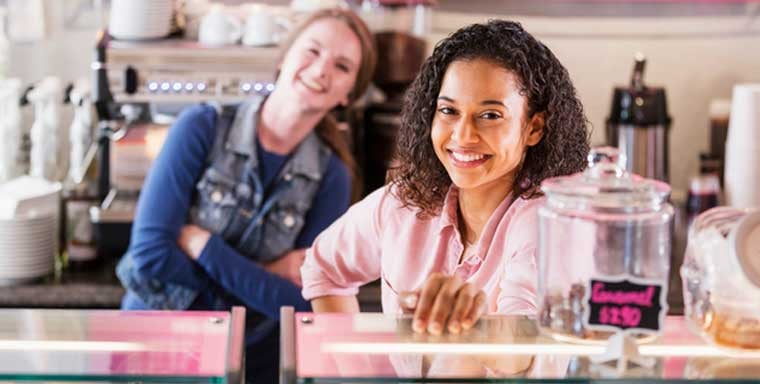 A local franchisee standing in her storefront