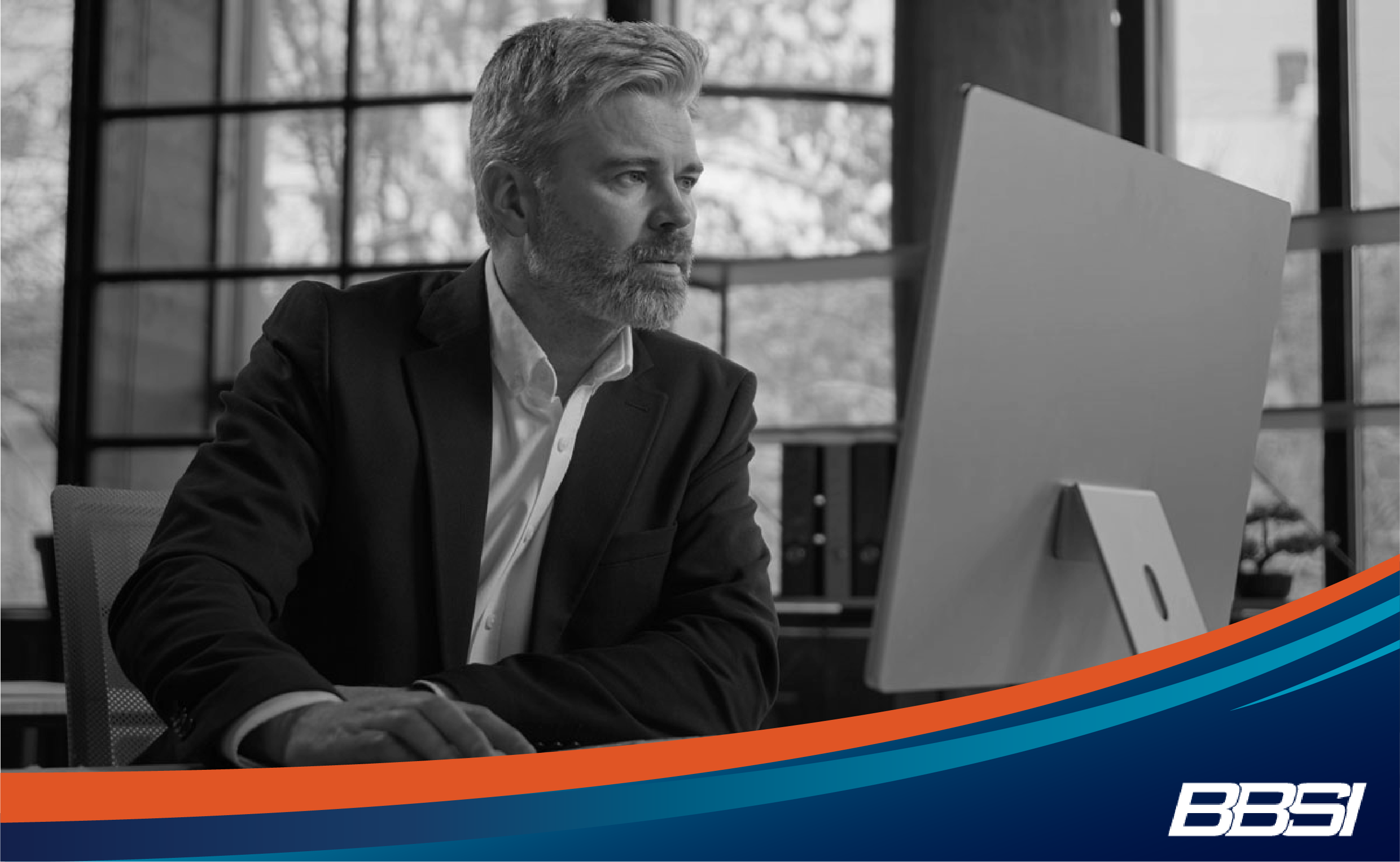  Business owner researching benefits compliance on computer.