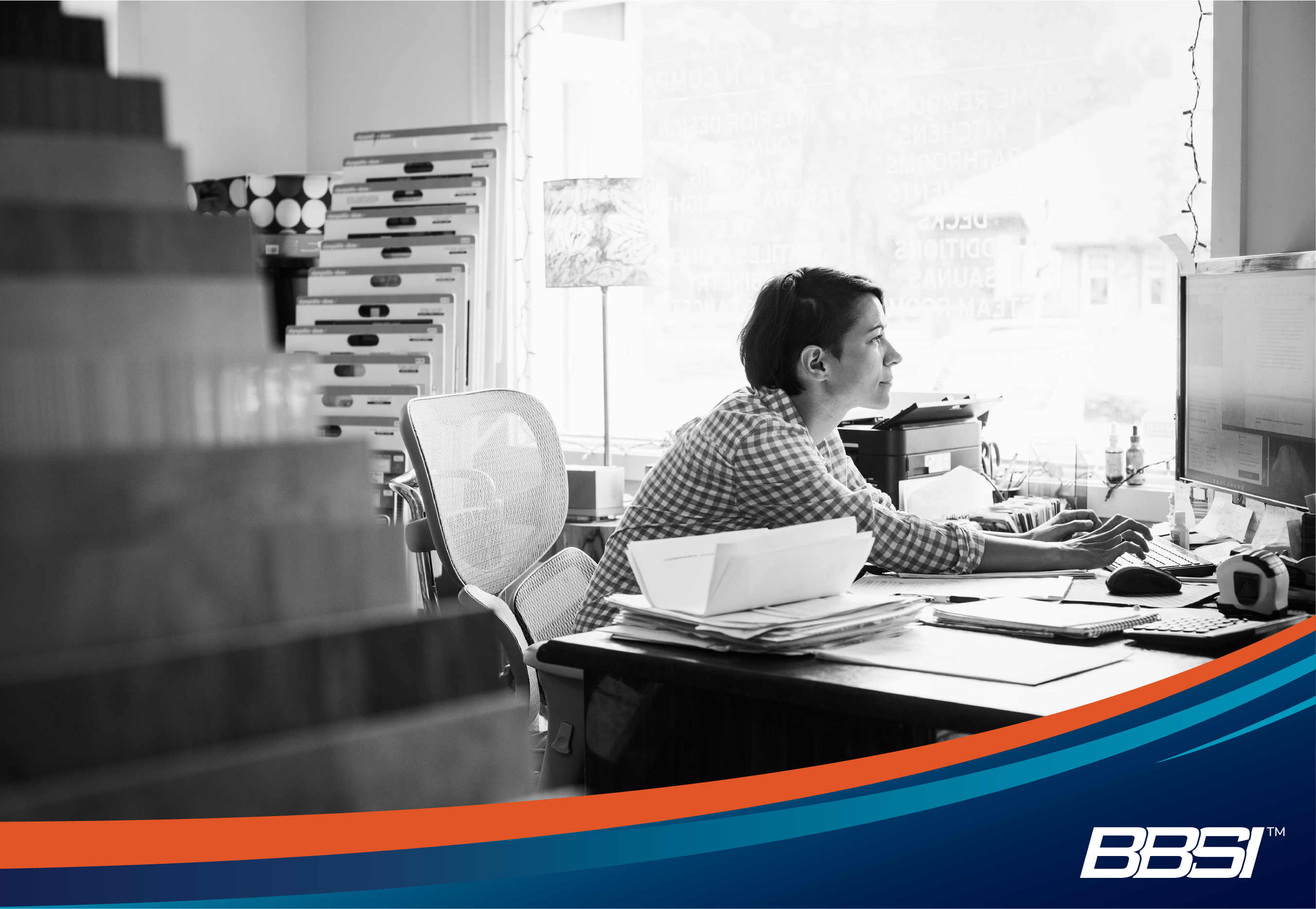 Woman working in an office reviewing her HR compliance checklist