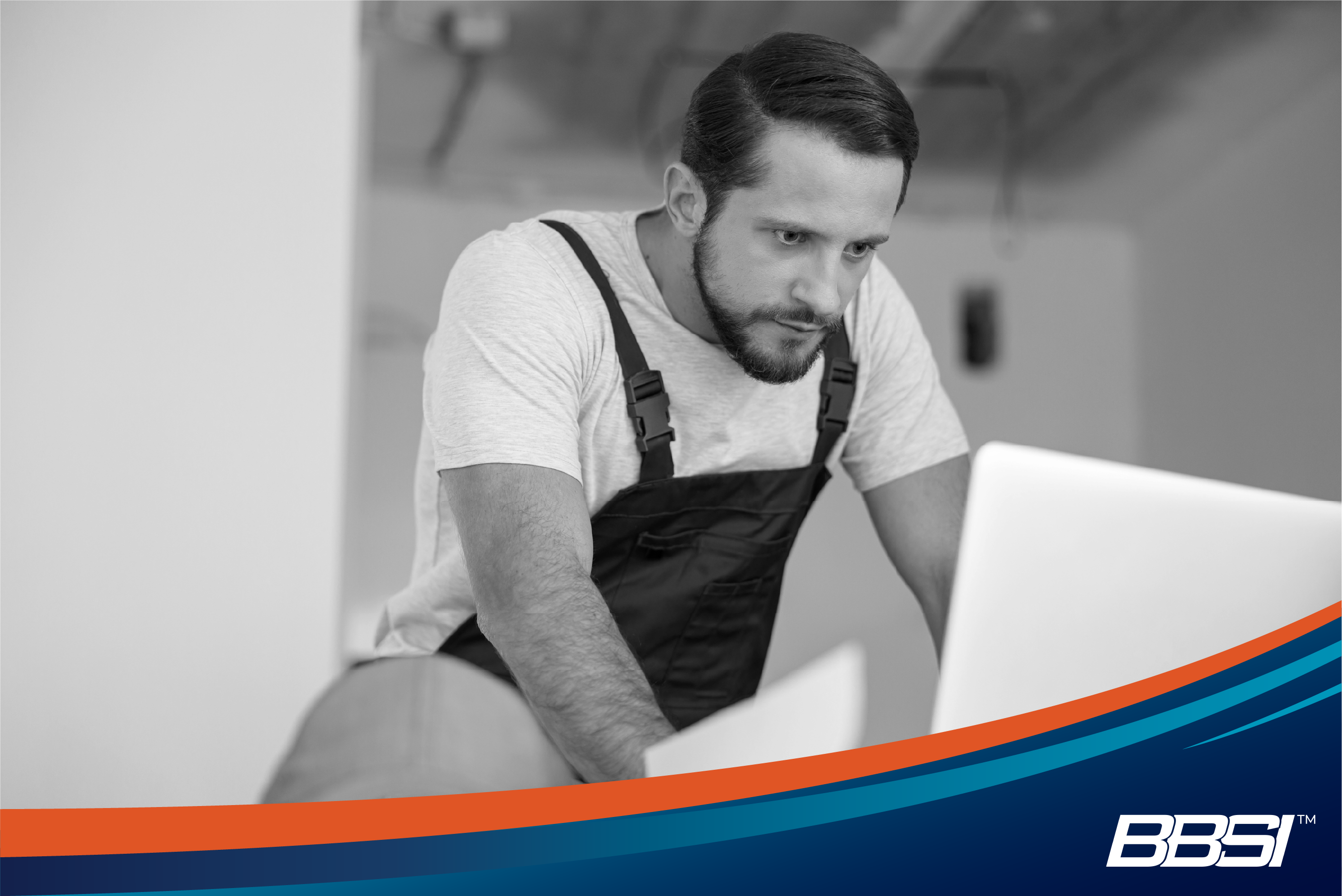 Worker in apron using computer to streamline HR tasks through PEO solutions.