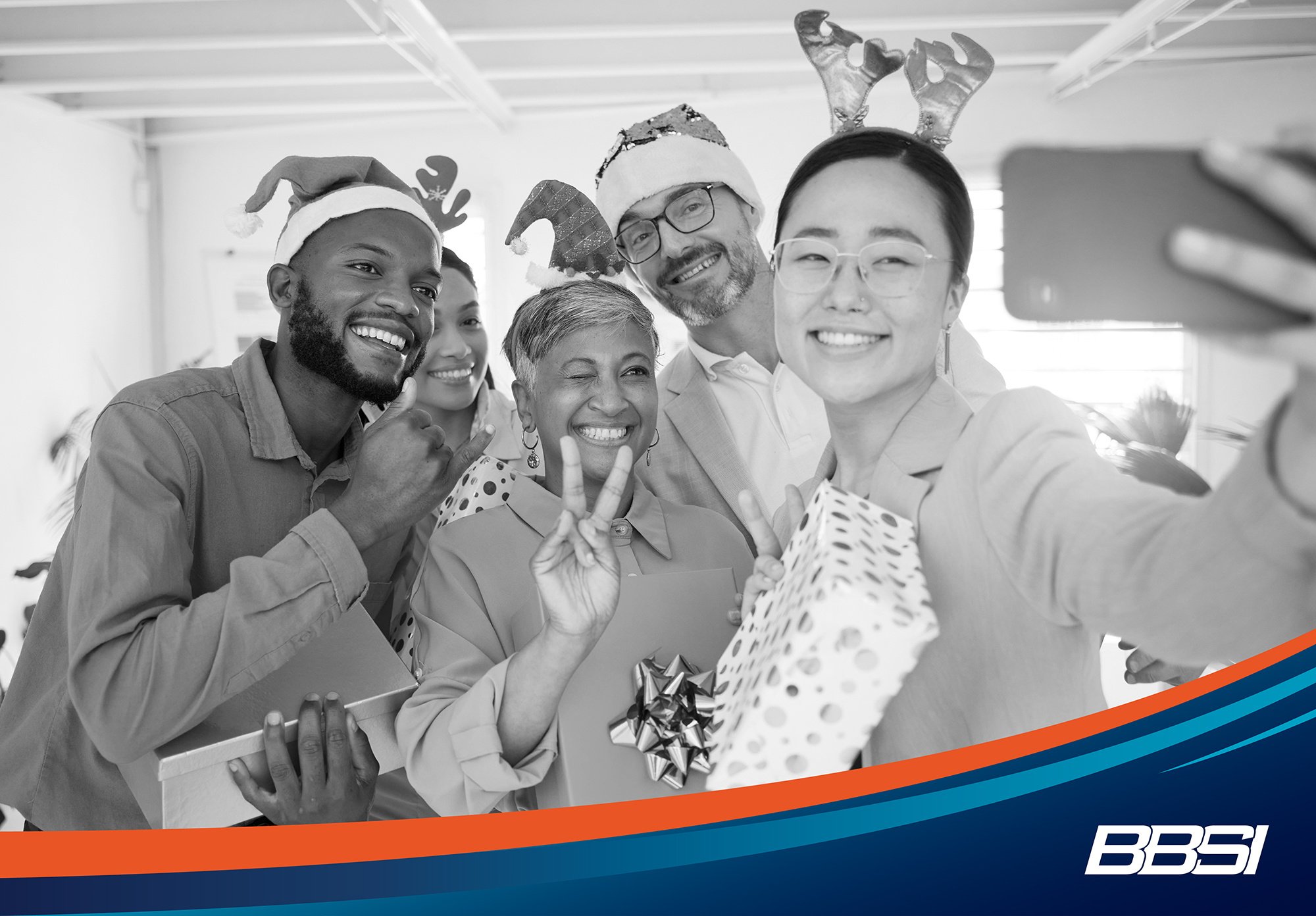 Coworkers taking a selfie after receiving their holiday bonus
