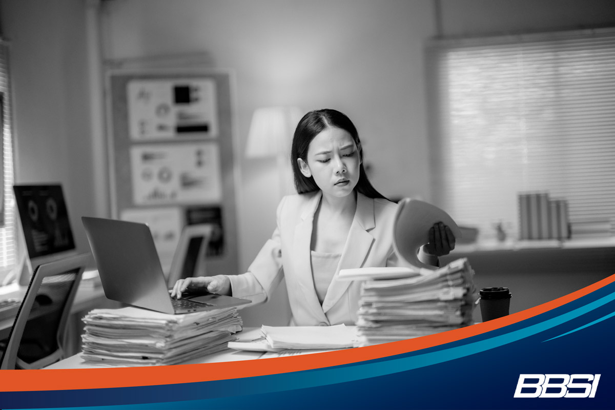 Business woman trying to stay on top of her HR tasks