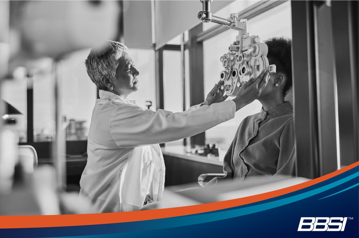 Employee receiving a vision check as part of group health insurance benefits