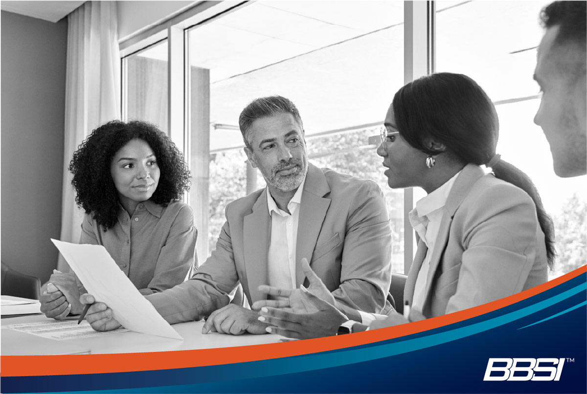 Insurance brokers discuss benefits enrollment with business owners