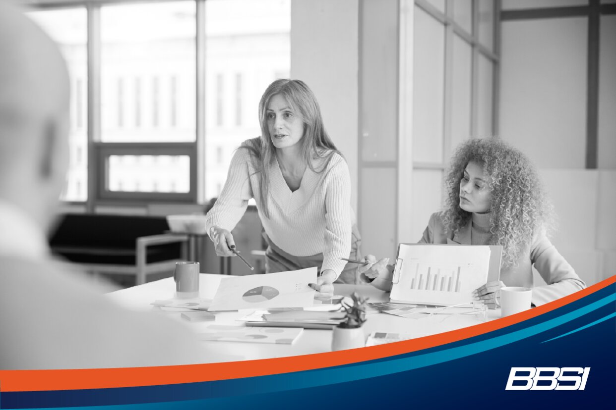 Businesswoman presenting reports and charts in a business meeting with a colleague.