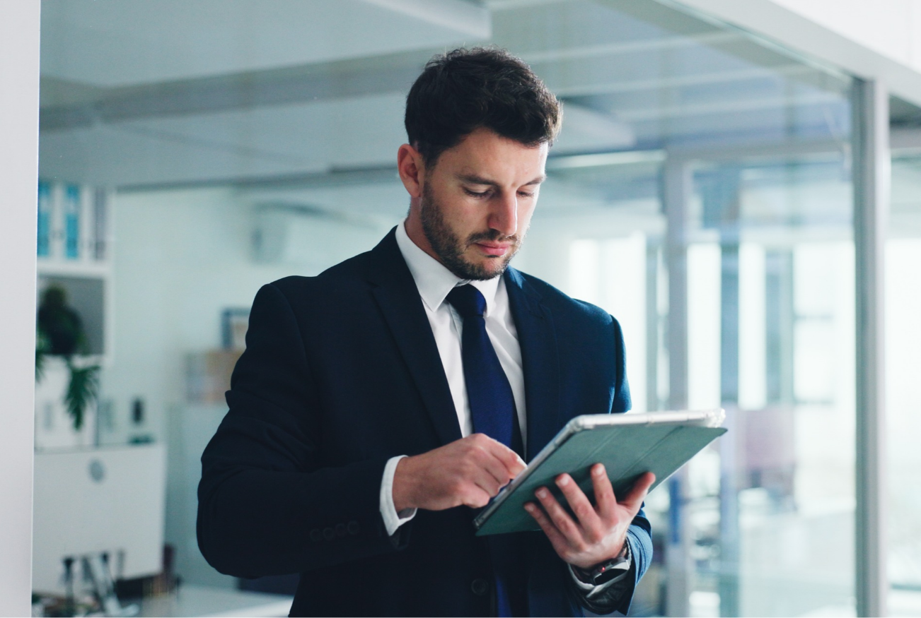 Business professional checking his open enrollment checklist on his laptop