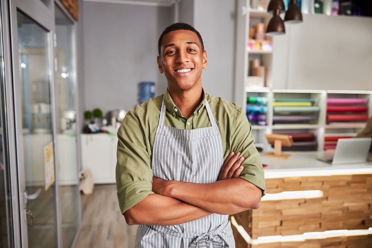 Franchise owner standing in his shop, smiling