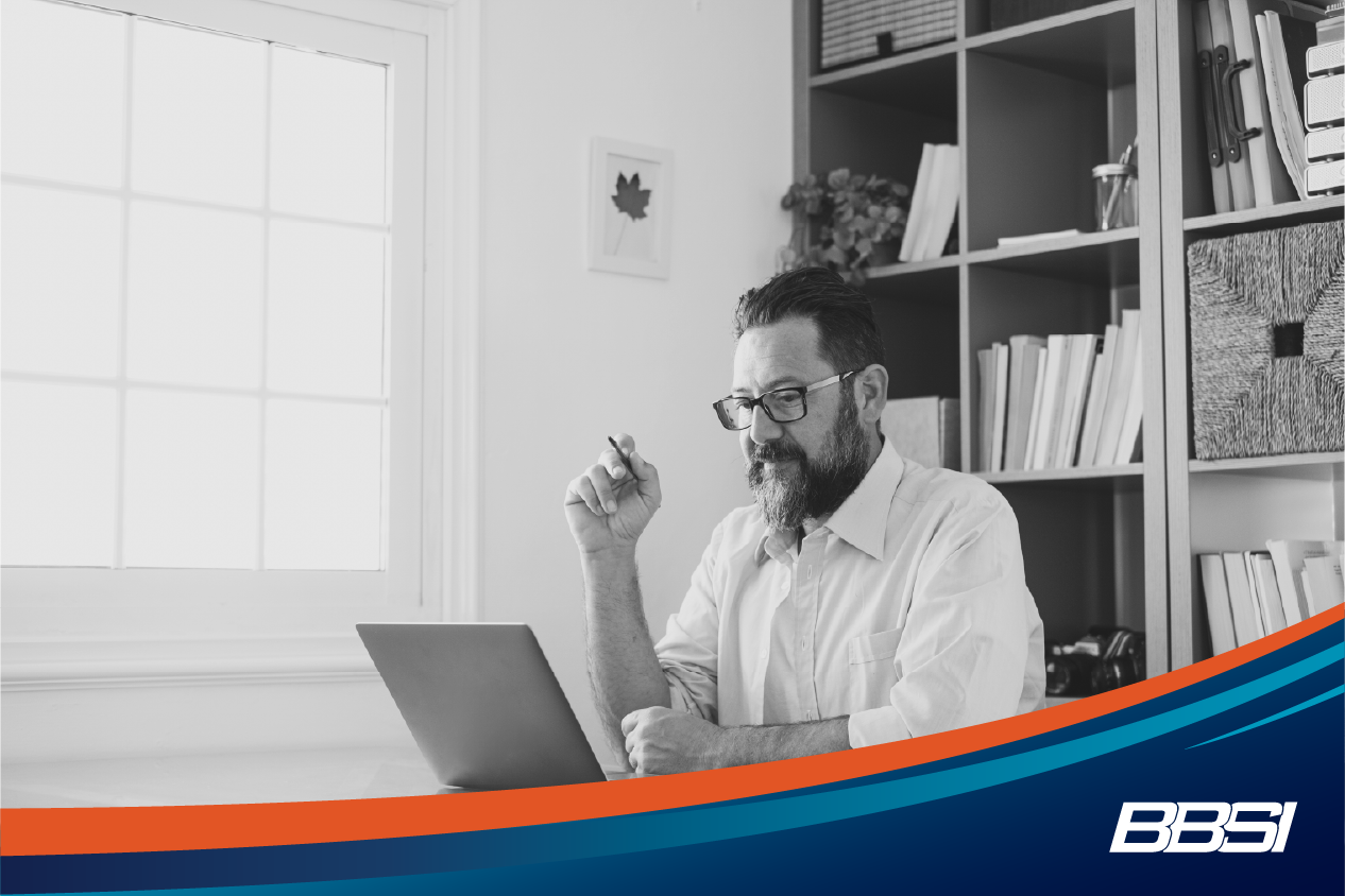 A man working at his computer in his home office