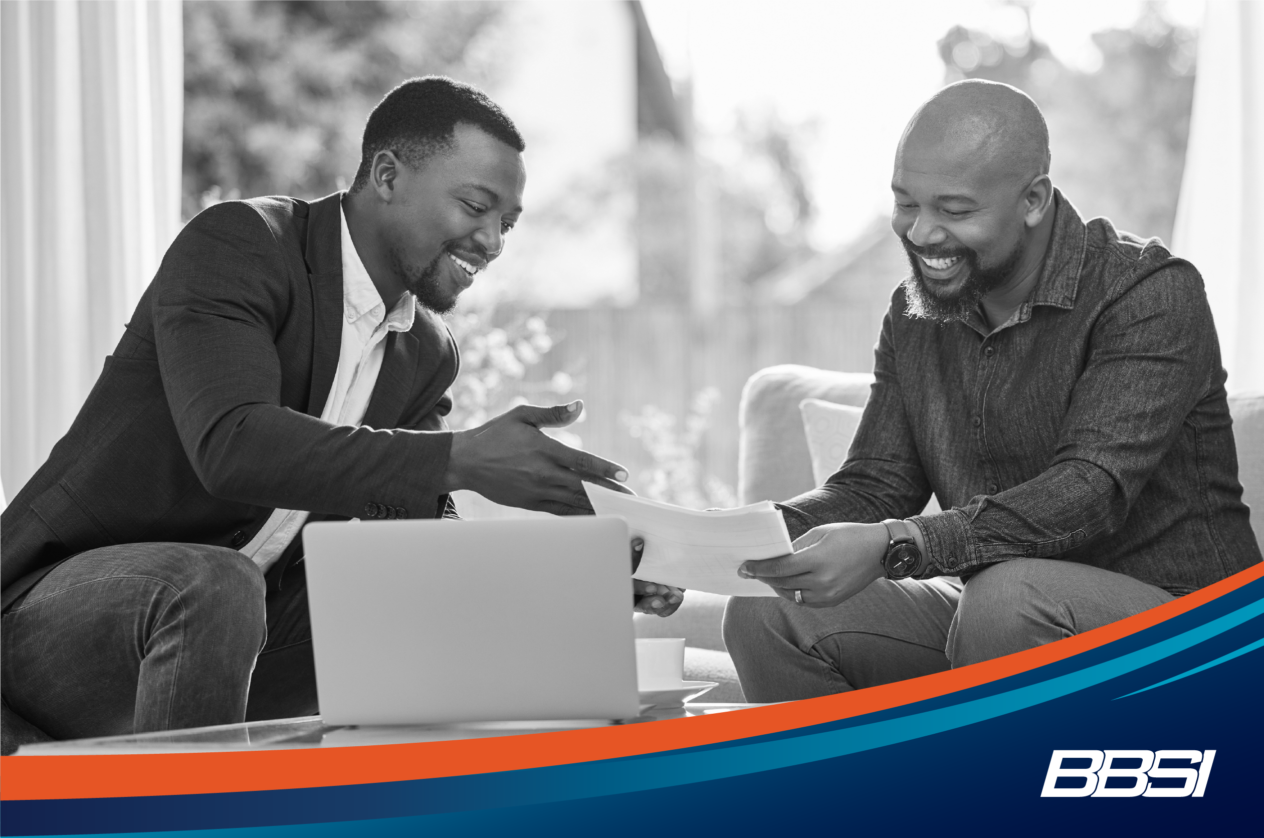 Broker selling health insurance to a man in an office.