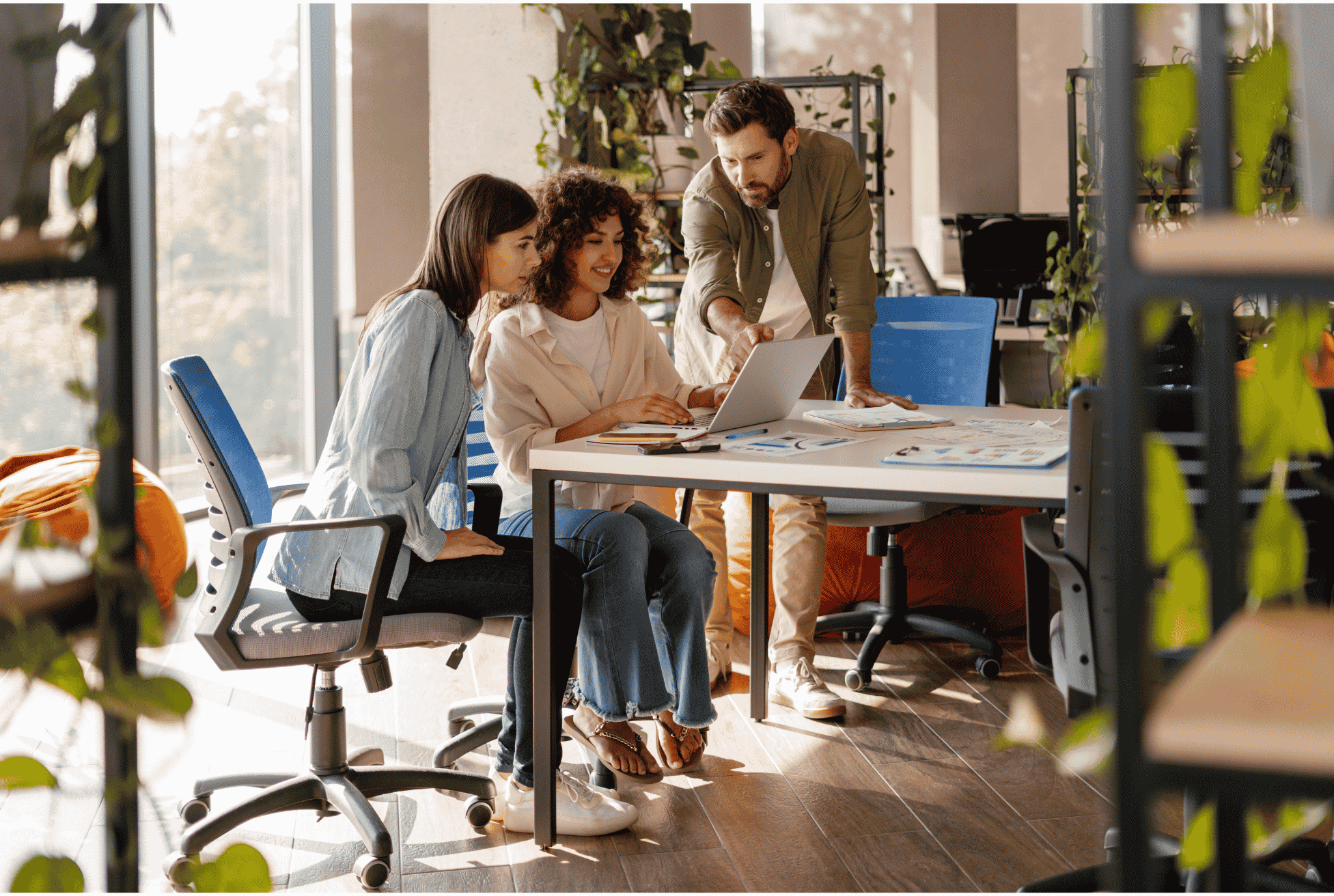 Small business owners researching benefits administration services in a modern office