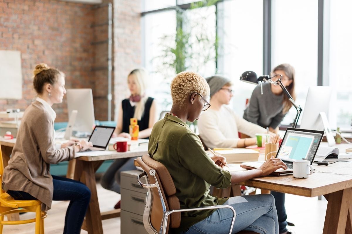 Small business team who’s partner with a PEO working in bright office