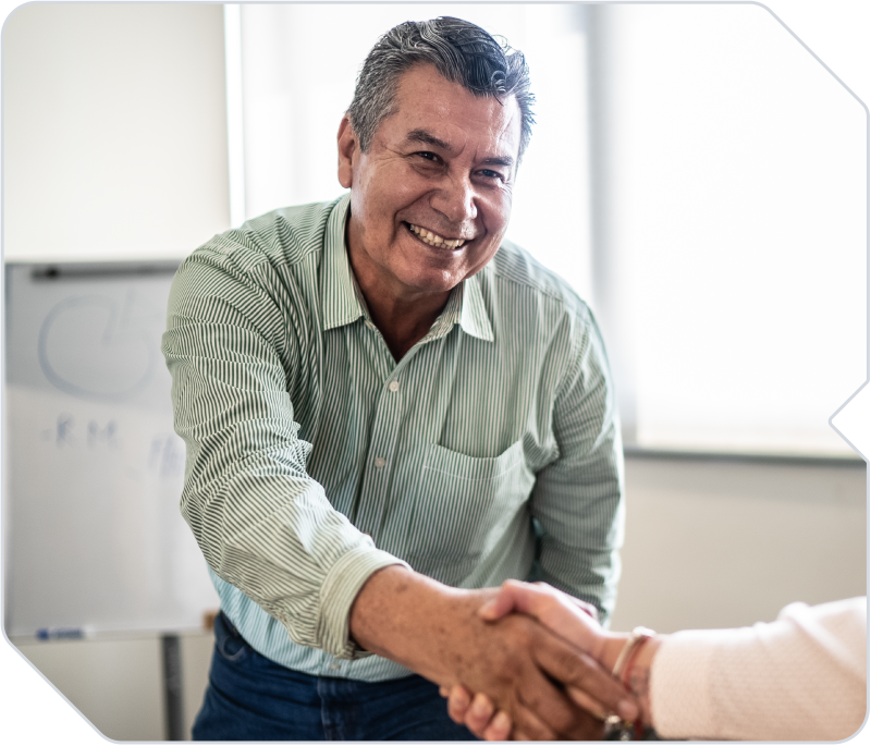 An insurance client shaking hands with his broker.