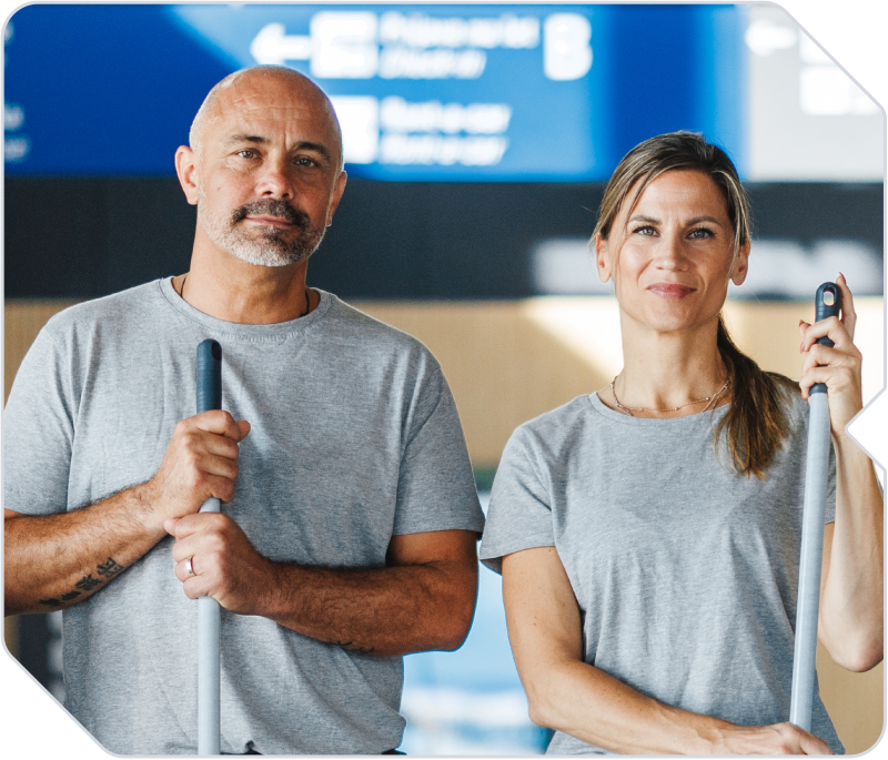 Two janitorial workers working together to solve operational problems