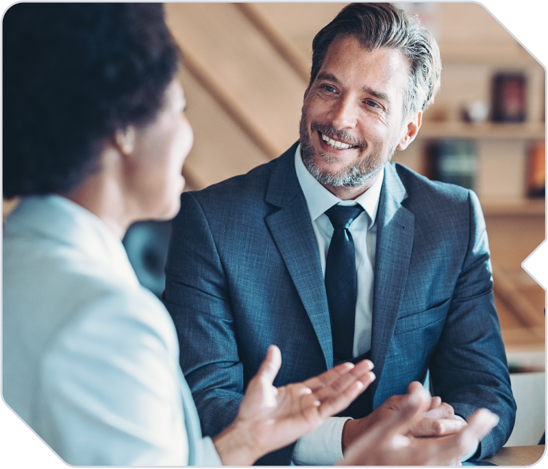 Two business owners discussing strategy at a coffee shop.