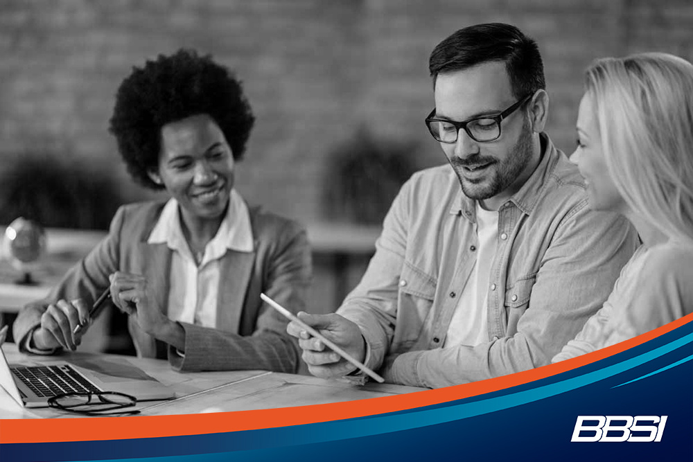 professionals discussing a workers' compensation insurance policy
