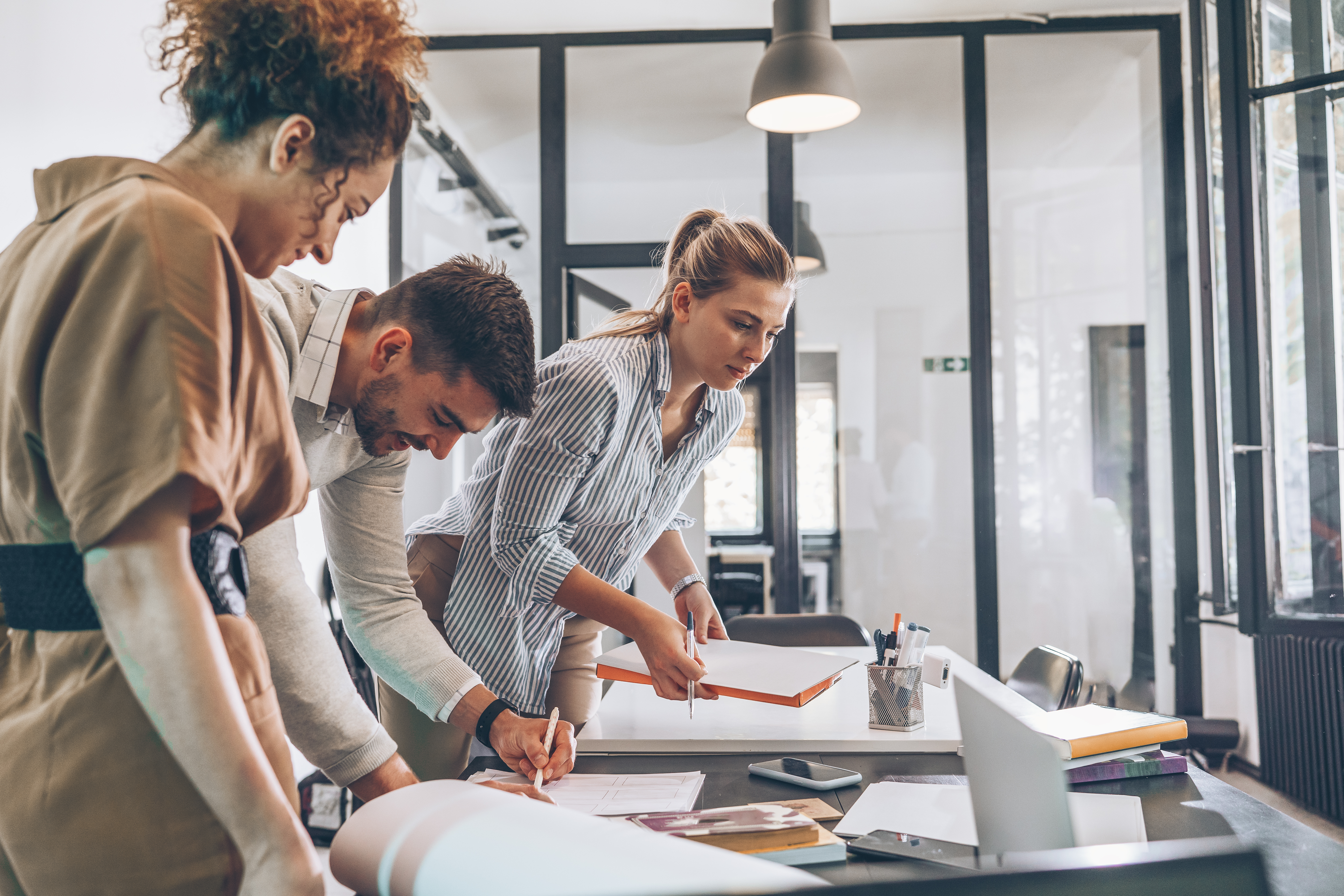 Group of professionals working in an office solving HR challenges