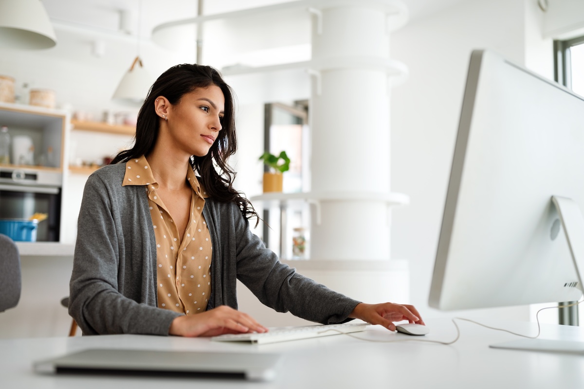 Business owner managing payroll on her computer